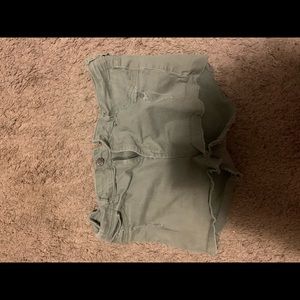 Green ripped shorts